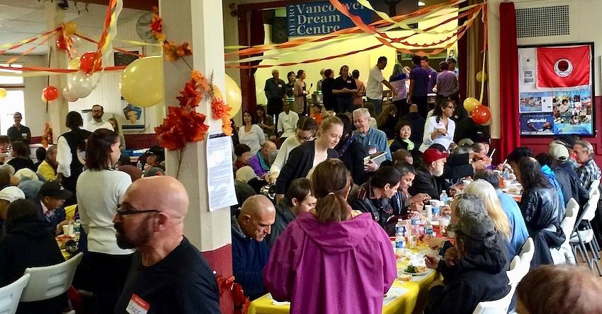 Lots of people eating in the church hall