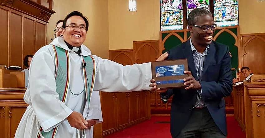 Photo of Moses holding the plaque