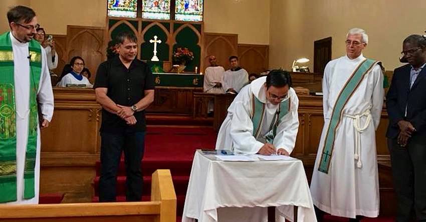 Photo of Reverend Wilmer signing the covenant
